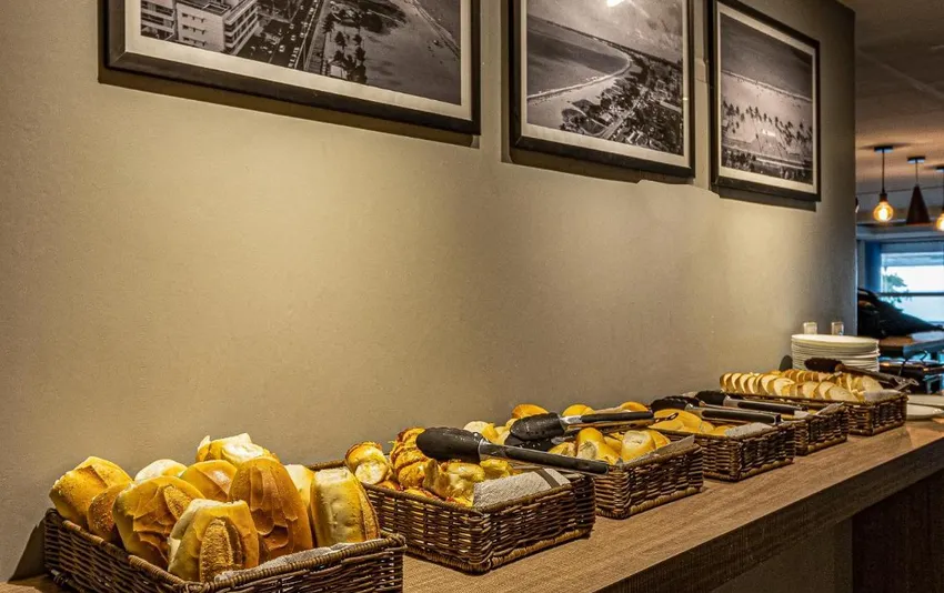 Foto de uma bancada com várias cestas de pães variados