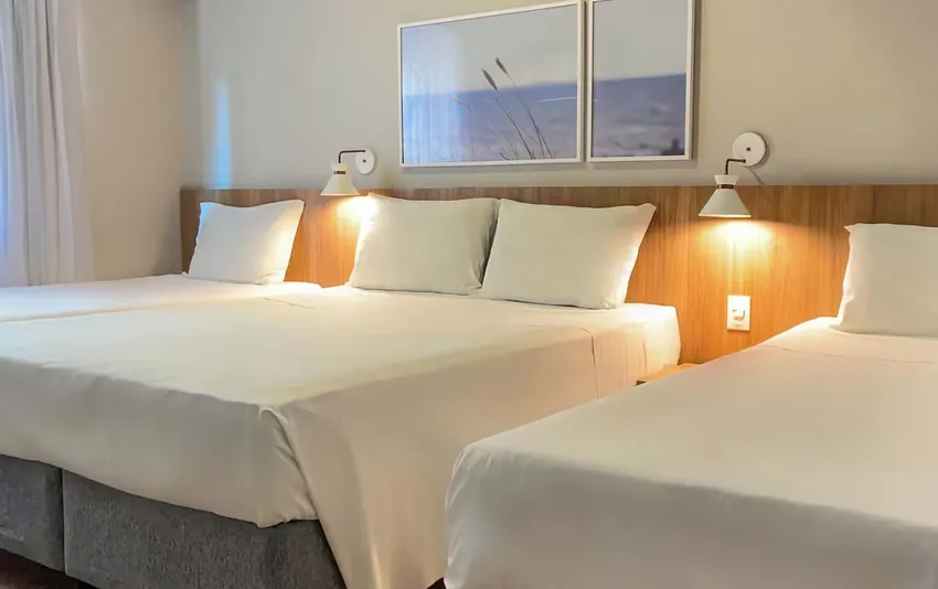 Foto de um quarto de hotel moderno com cama de casal, cabeceira iluminada