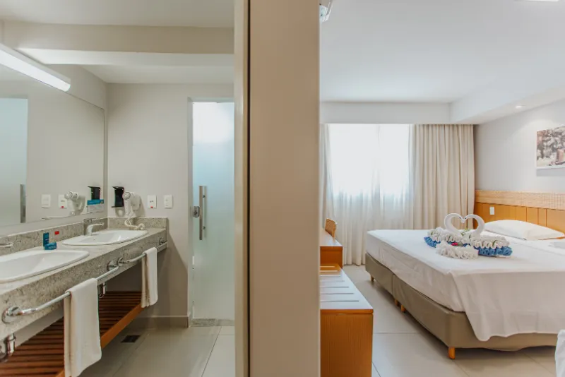 Foto mostrando como é a visão do quarto com uma divisão no banheiro do hotel